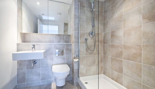 A modern bathroom with natural stone tile walls
