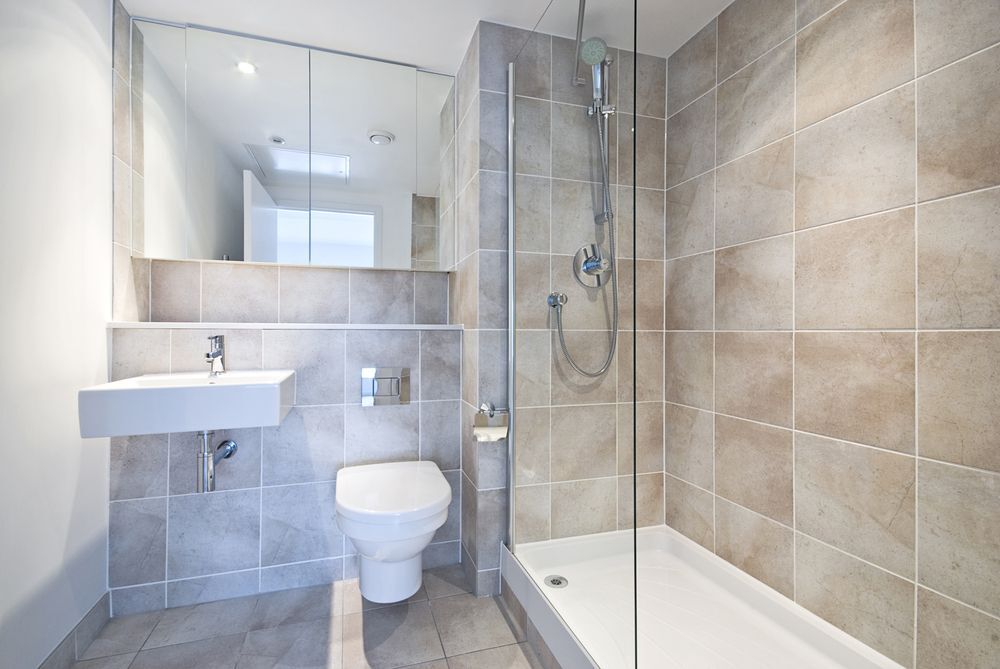 A modern bathroom with natural stone tile walls