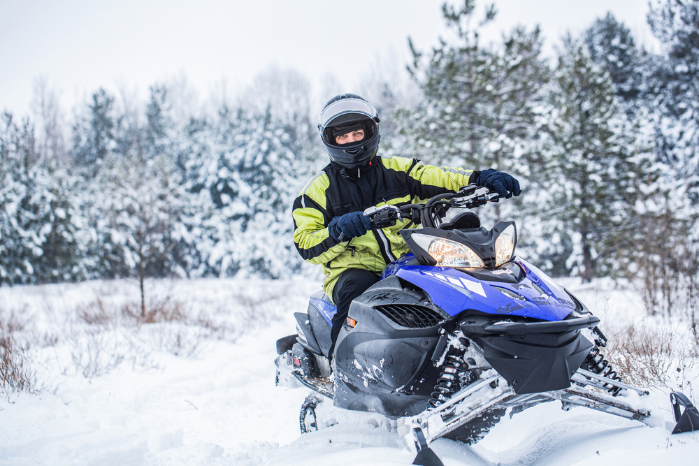 man snowmobiling in cottage country
