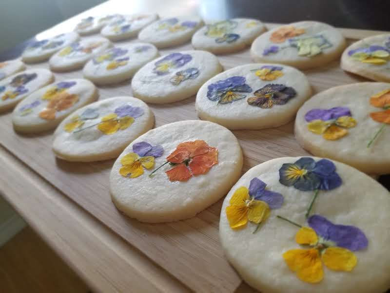 pressed flower cookies on a board