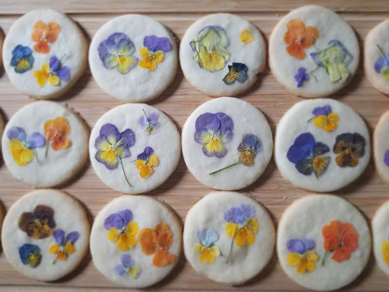 Pressed flower cookies on a board