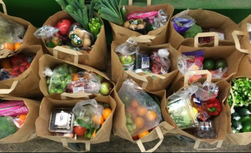 brown paper bags full of fresh produce
