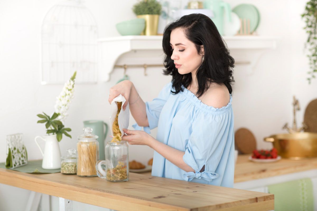 a woman sets up a zero-waste cottage kitchen