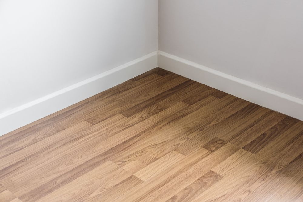 A laminate floor against white walls