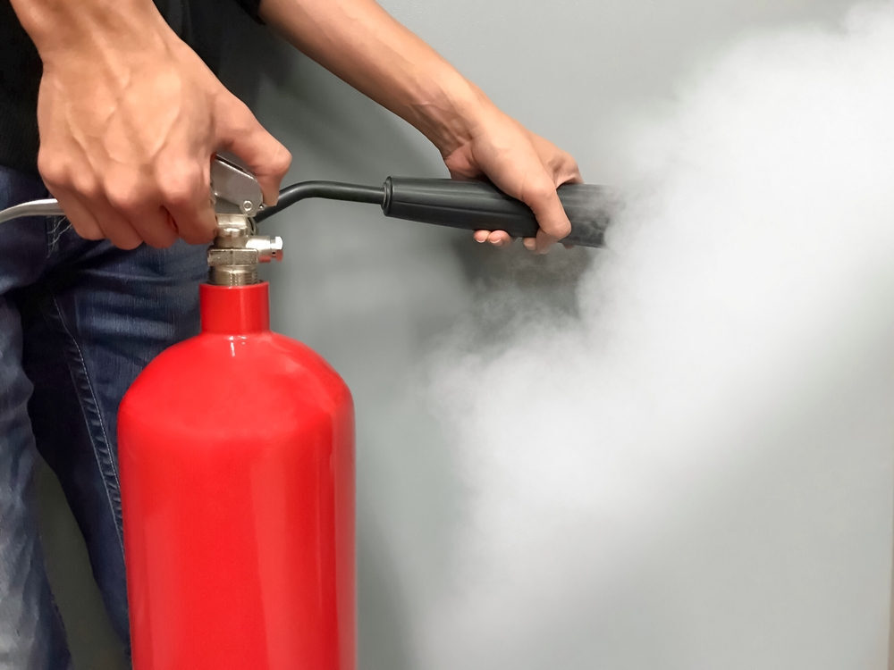 A fire extinguisher being used.