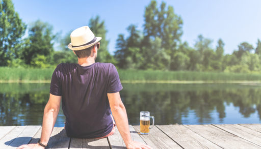 Man sitting on dock with beer