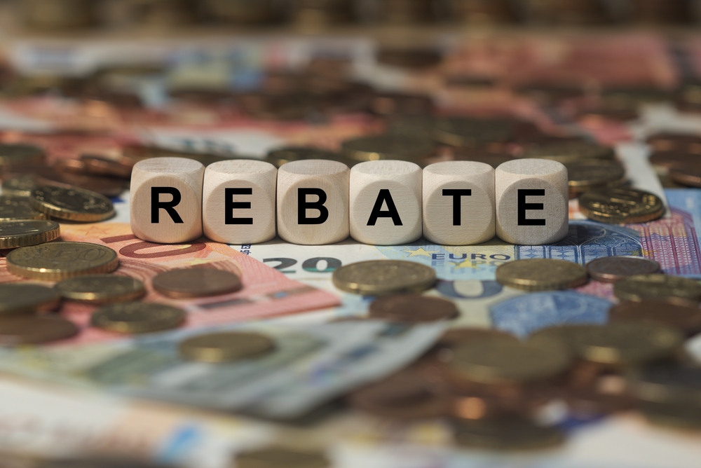 Cubes spelling out the word rebate, surrounded by money.