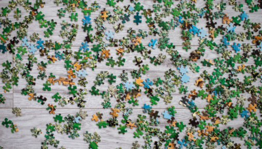 Puzzle pieces scattered on table