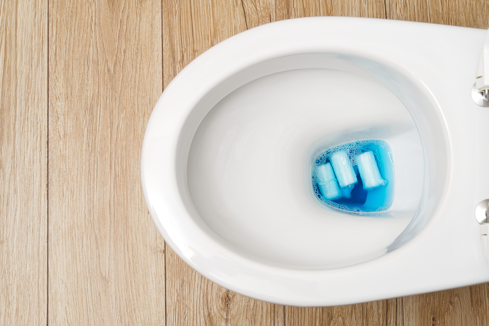 Close-up of a toilet bowl clogged with personal hygiene products, septic tank