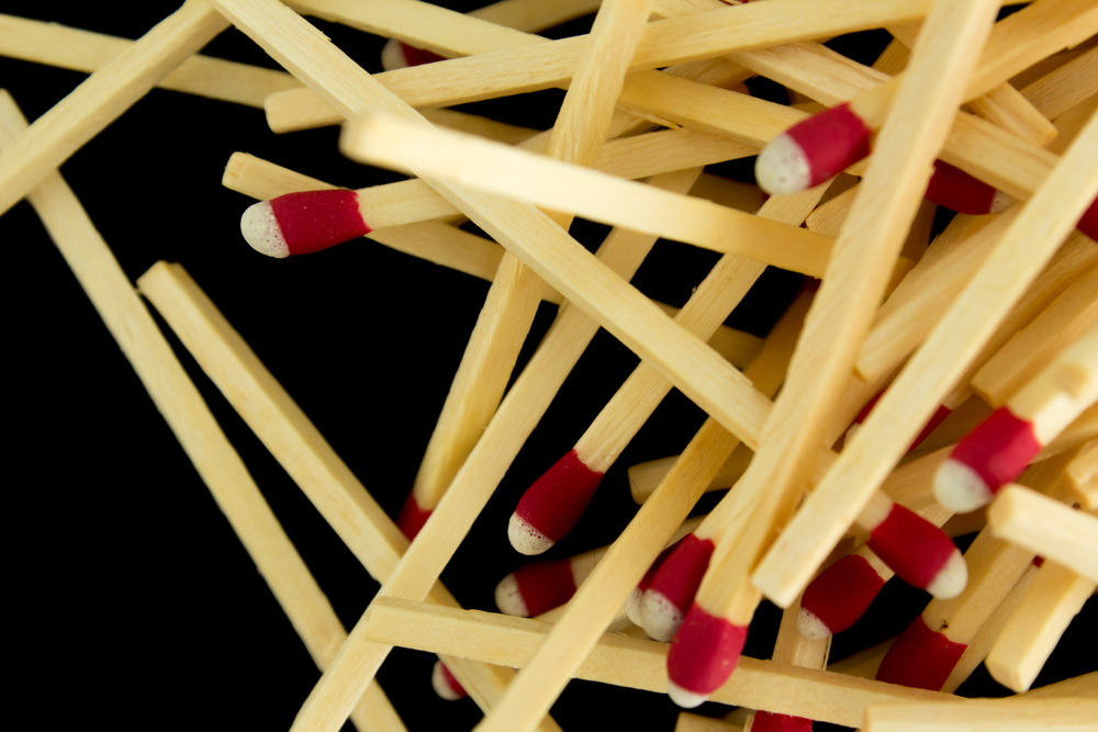 A pile of strike-anywhere matches against a black background
