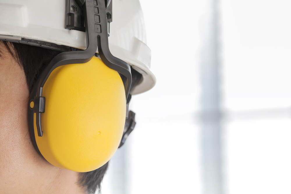 Man wearing safety helmet and hearing protection.