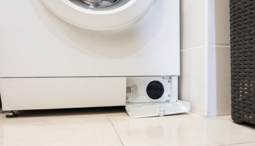 Washing machine with an open filter cover, appliance