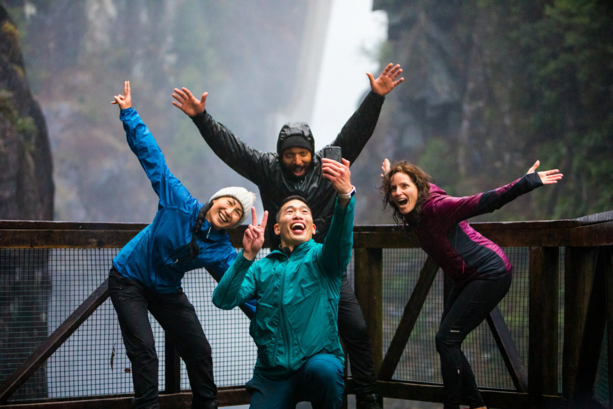 A group of hikers taking a selfie in front of a Trans Canada Trail waterfall