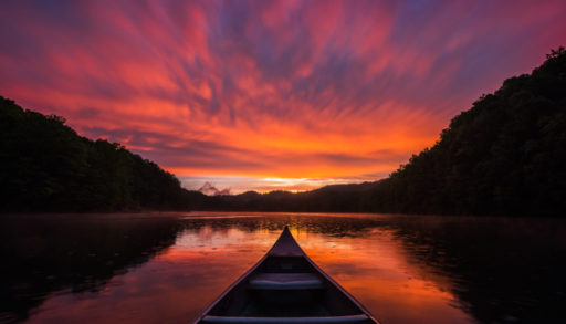 Bow of a canoe in a dramatic sunset