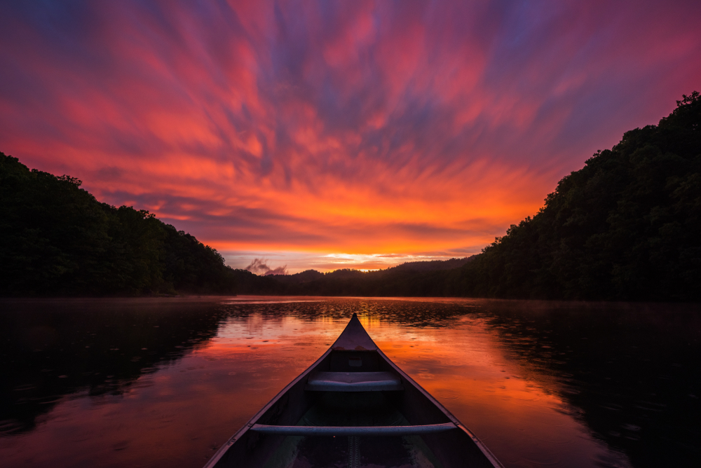 Bow of a canoe in a dramatic sunset