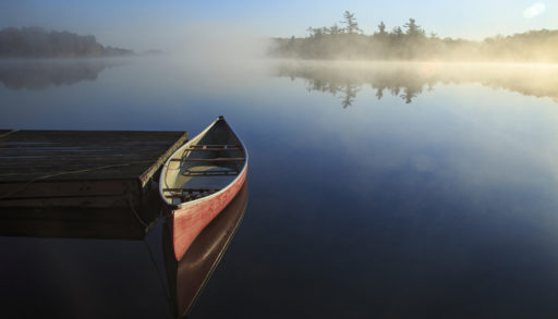Beautiful canoe in still lake