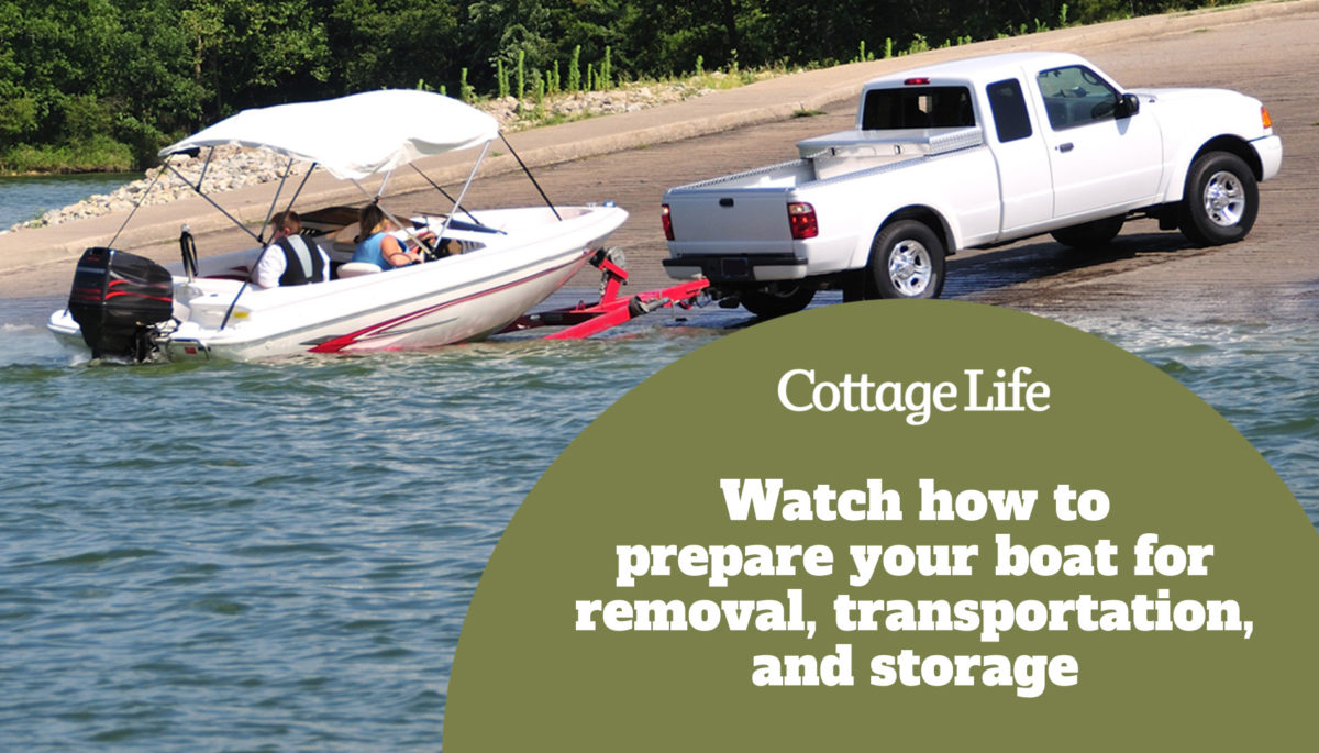 boat being loaded onto a truck's trailer on boat ramp