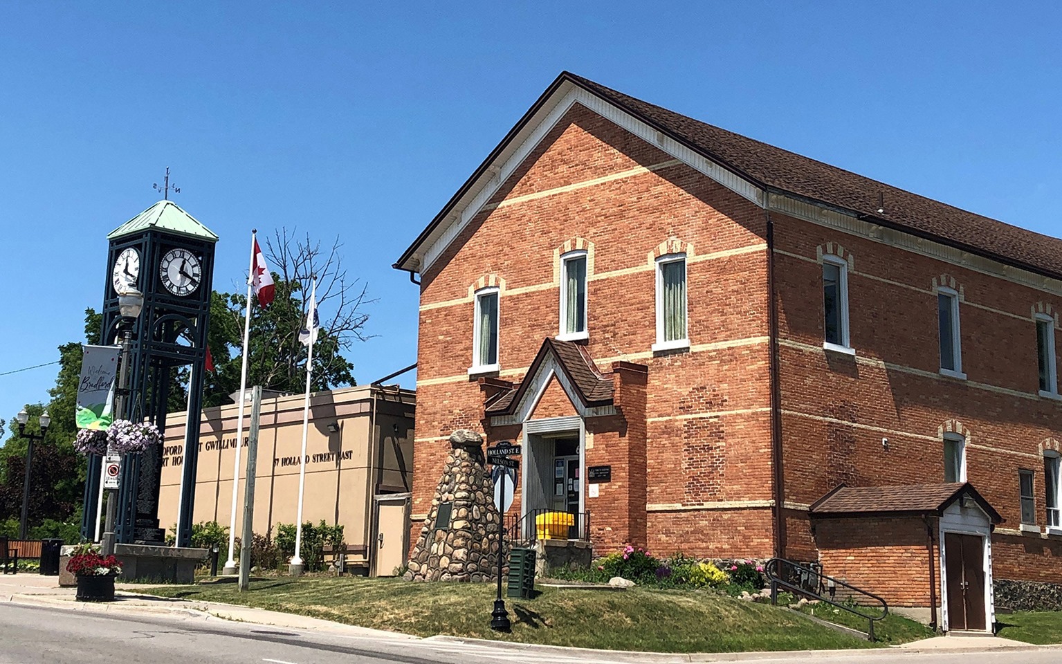 an old historic building next to a clock tower in bradford, ontario, ontario town