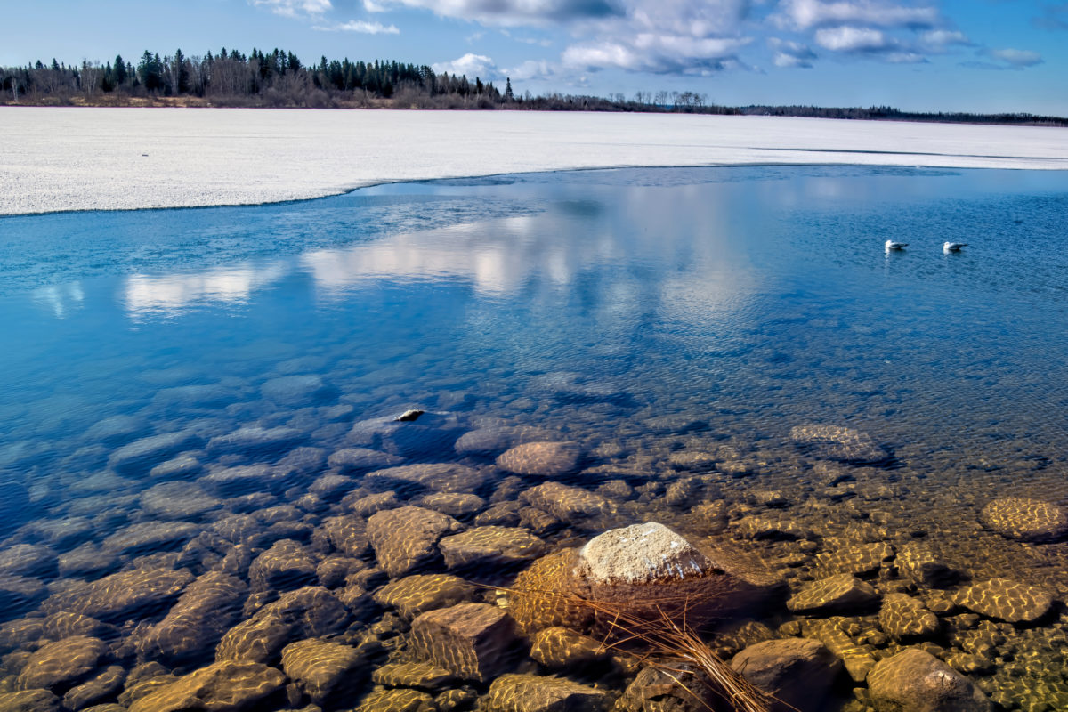 View of Lac la Ronge on a calm early morning during the spring ice melt.