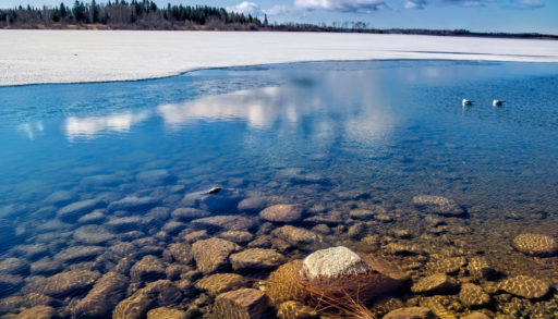 View of Lac la Ronge on a calm early morning during the spring ice melt.