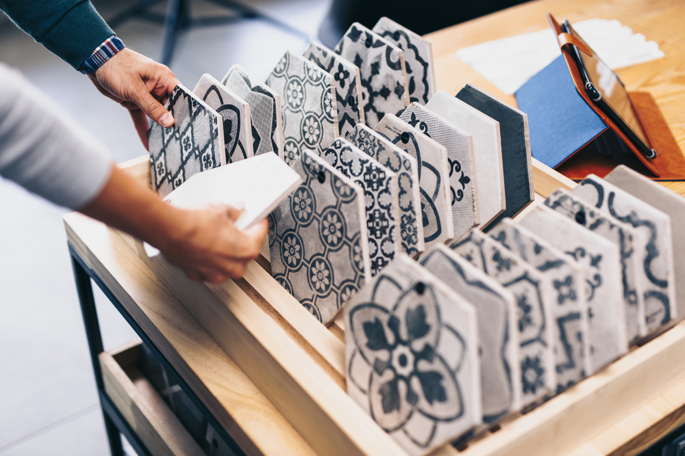 Middle age couple choosing new ceramic tiles to replace a cracked tile