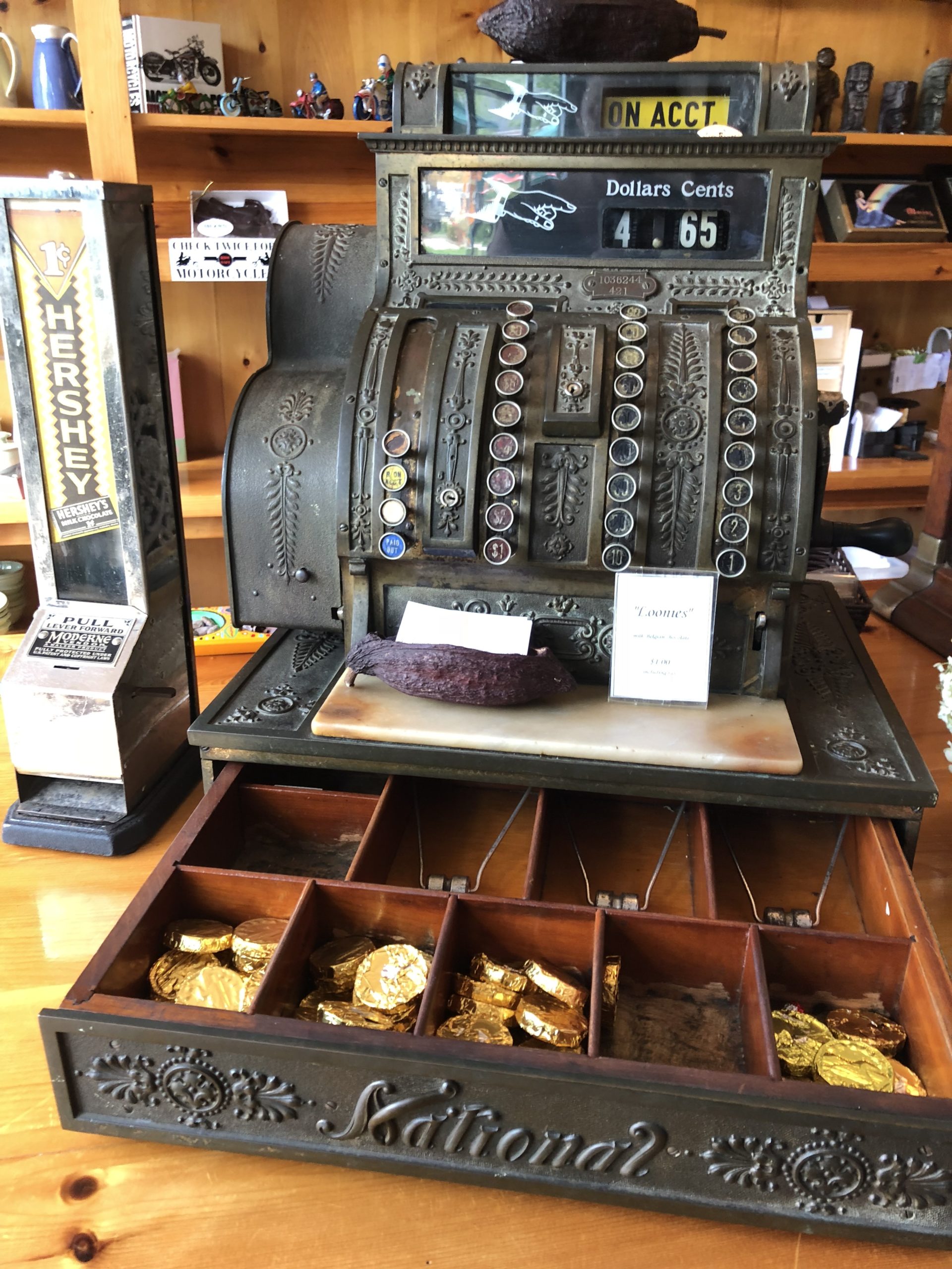 a photo of a cash register with chocolate coins inside Island Chocolates, Victoria-by-the-Sea, P.E.I.