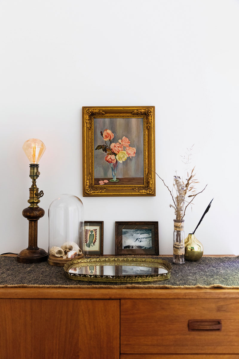 a vingette on top of a sideboard in Raina + Wilson's shared cottage