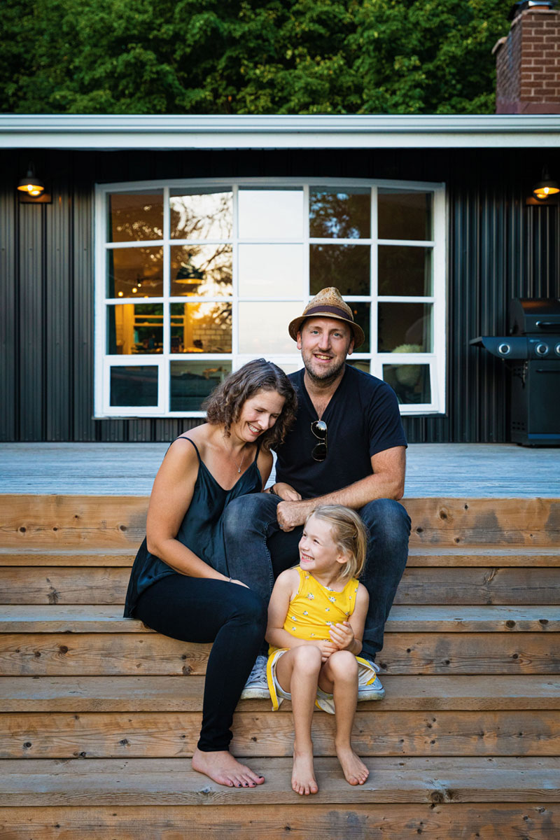 family photo outside Raina and Wilson's shared cottage