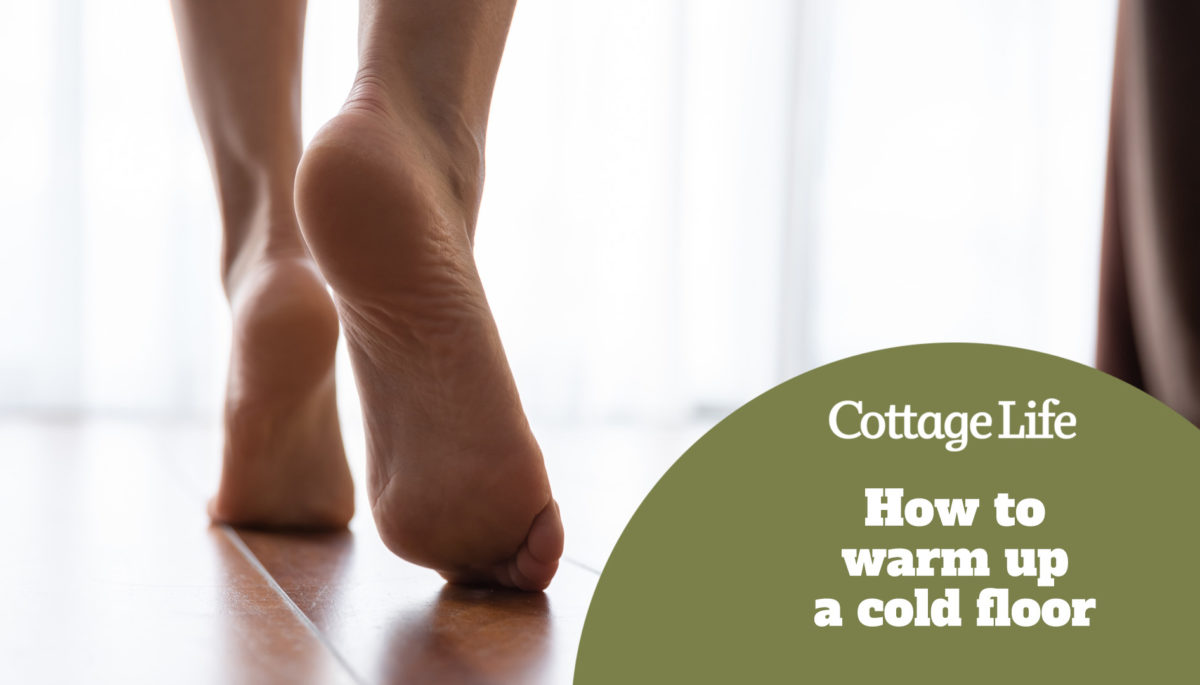 Female feet walking on warm heated floor close up view, barefoot girl legs going on hardwood living room wooden flooring at modern home house, domestic underfloor heating concept, close up rear view