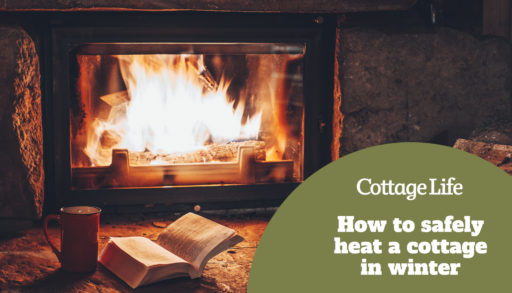 Open book by the Fireplace with Christmas ornaments. Open storybook lying on a wooden bench by the fireside. Cozy relaxed magical atmosphere in a chalet house decorated for Christmas. Holiday concept.