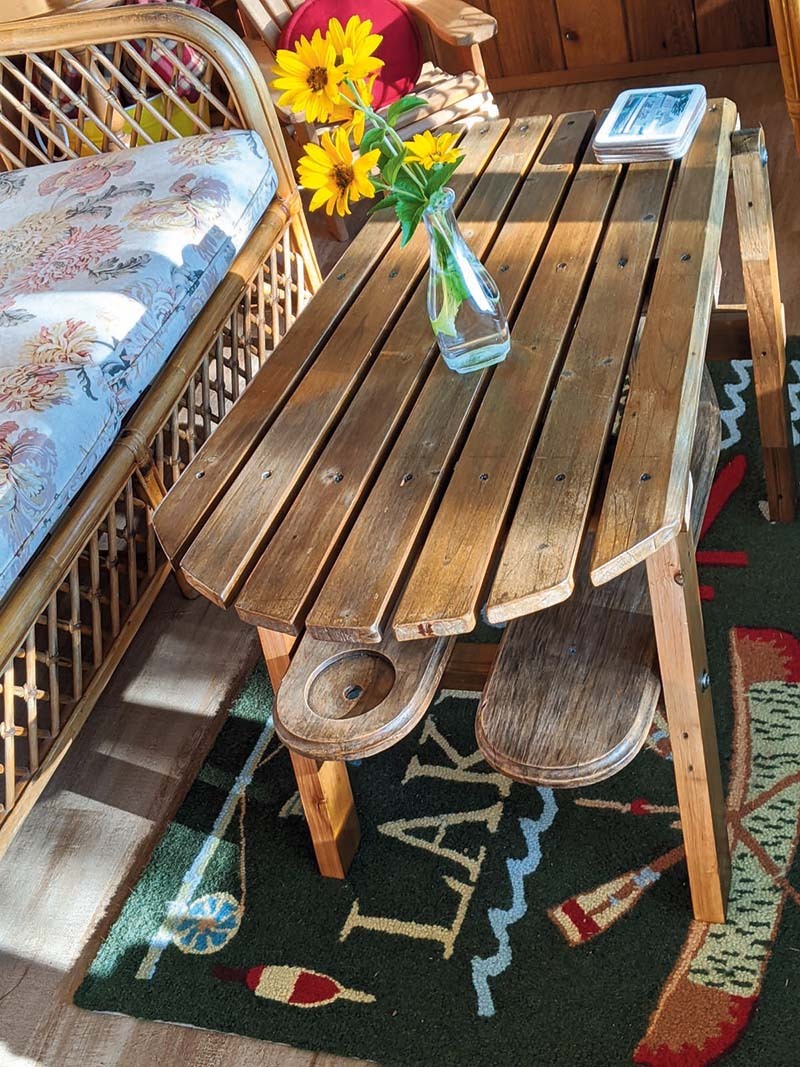 Muskoka chair turned into a table in a cottage sunroom