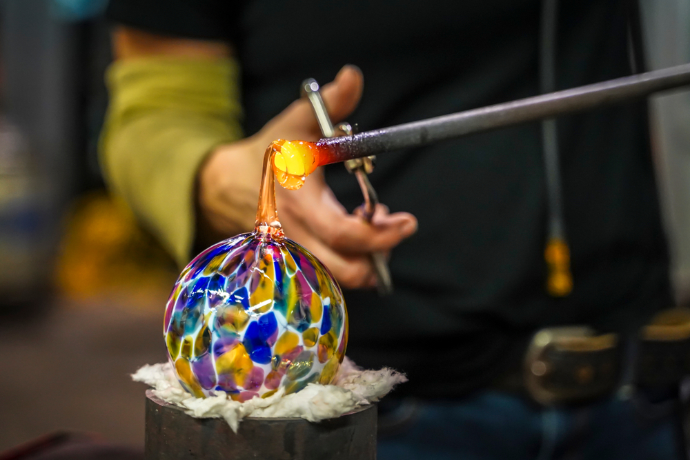 glass blower shaping an orb