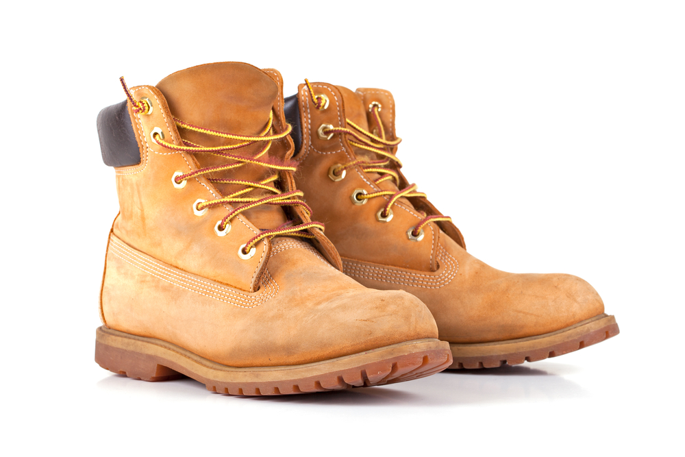Close-up of tan work boots against a white background