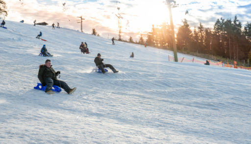 People on a tobogganing hill