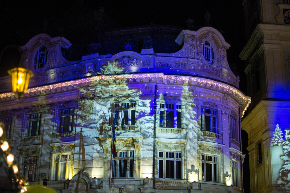 A building lit up with projection lights
