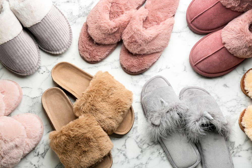 Multiple pairs of slippers against a white background