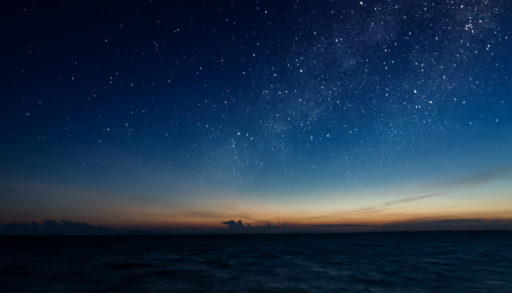 starry night over a lake at twilight