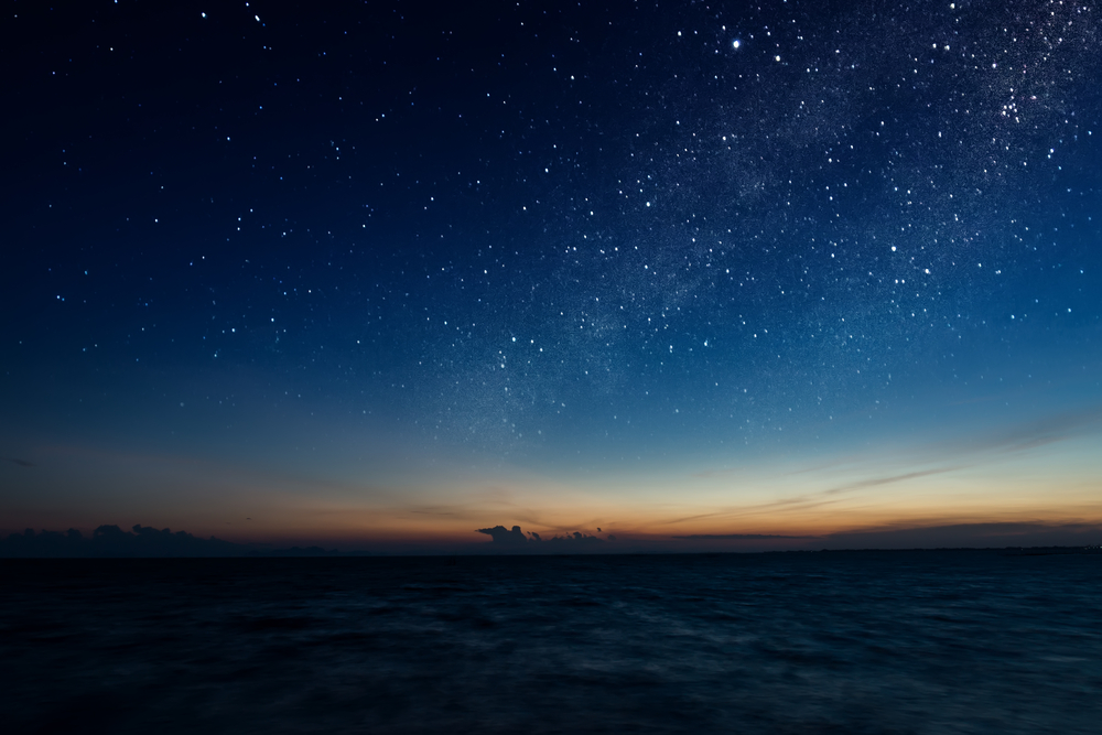 starry night over a lake at twilight