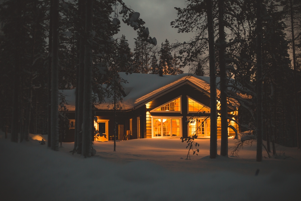 snowy cabin lit from within