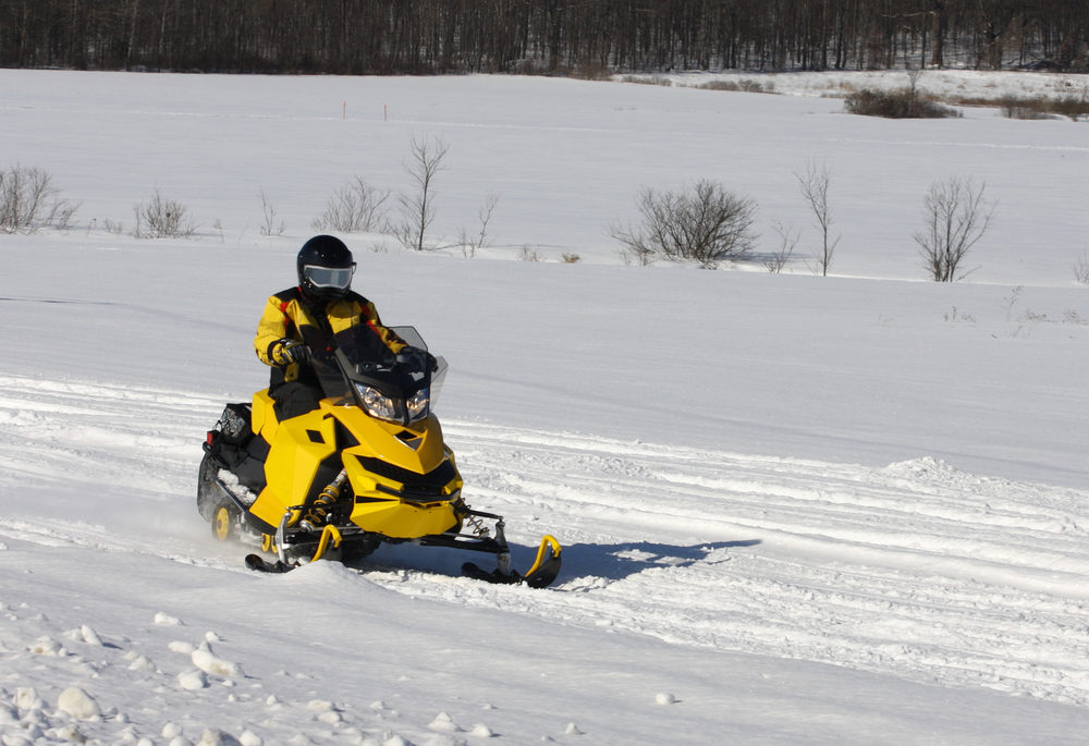 snowmobiler riding on a trail