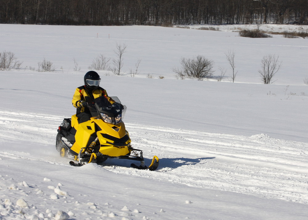 snowmobiler riding on a trail