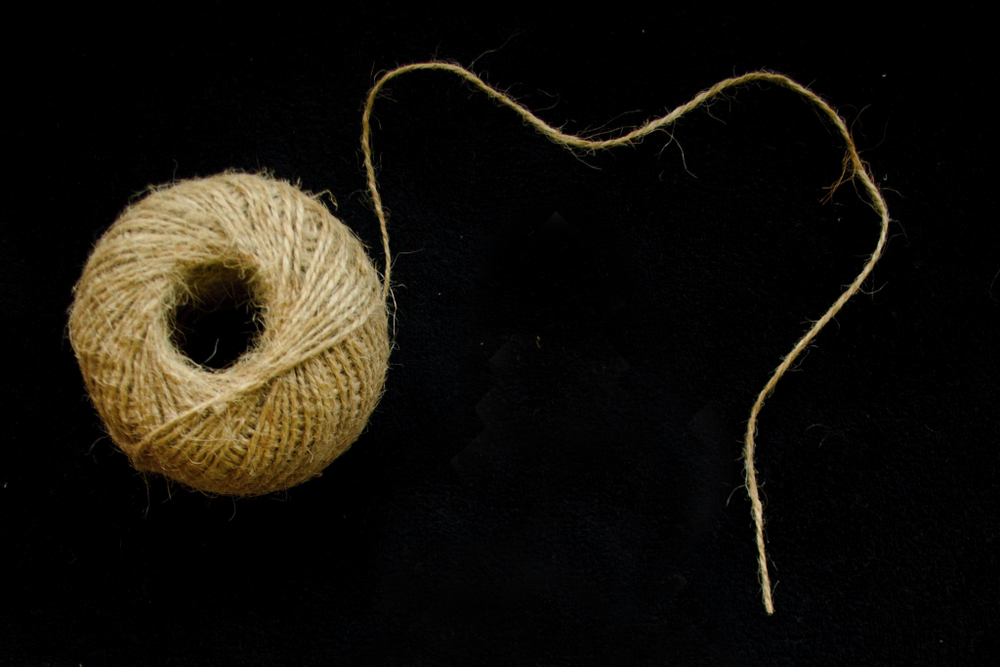 A ball of string against a black background