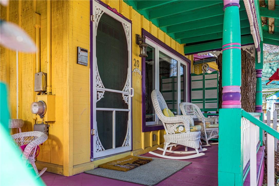 A close-up of the wide front porch with a white rocking chair.