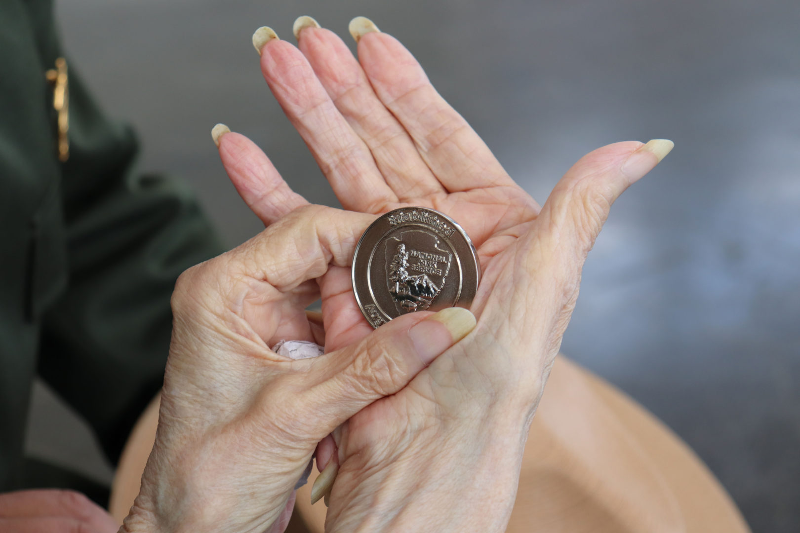 Betty holds the Challenge Coin.