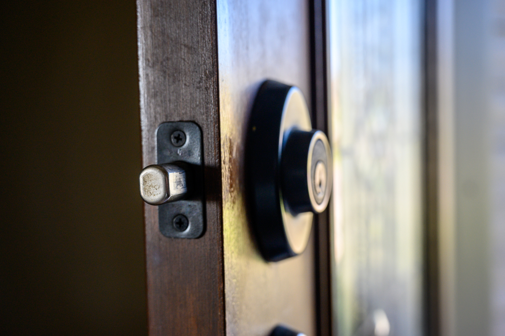 Close-up of a wooden door with a deadbolt lock with bolt extended
