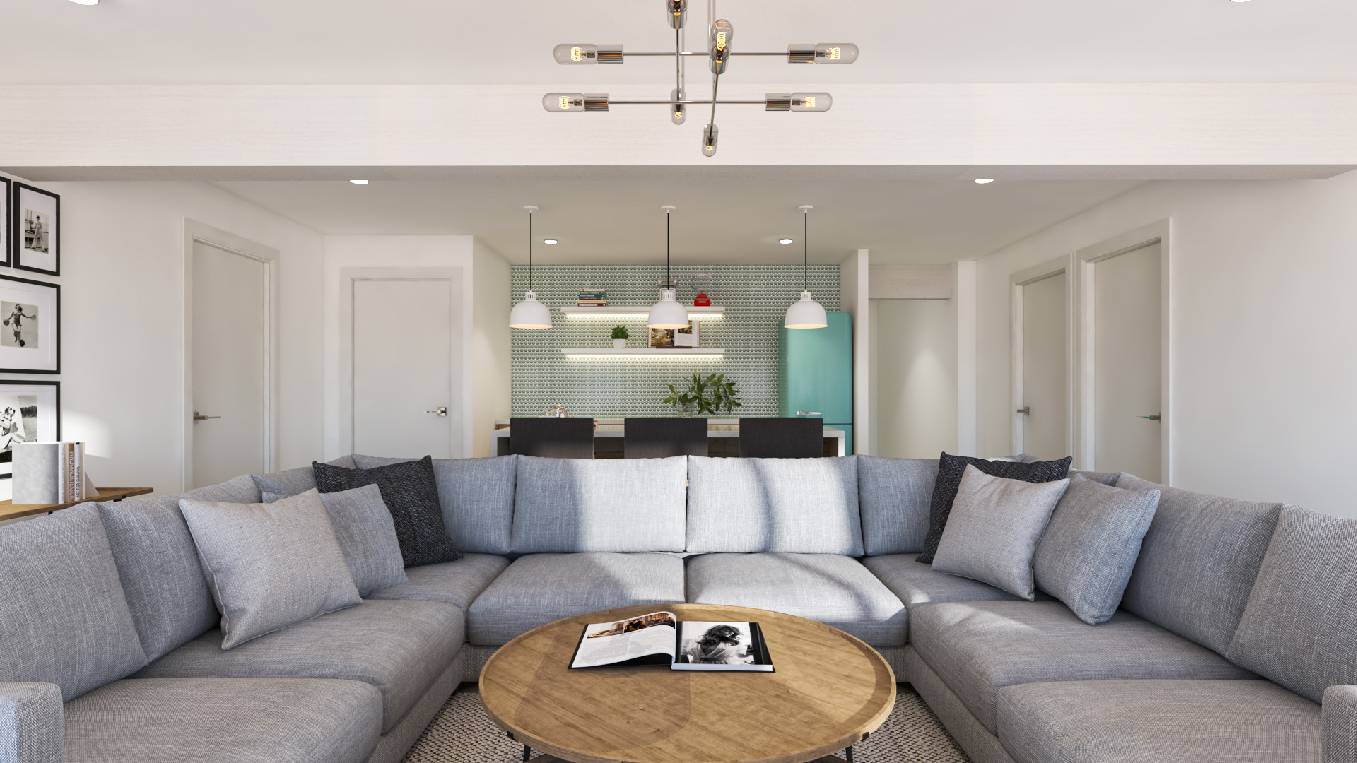 A room with a large grey sectional couch, and a blue-tiled juice bar area complete with a small island and stools.