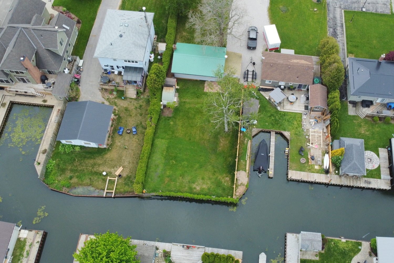 Aerial view of cottage showing backyard and boat channel