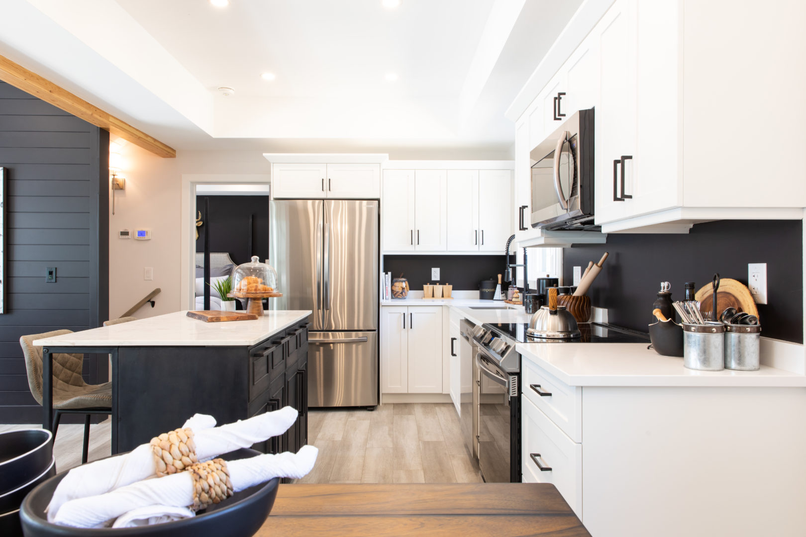 An open-concept kitchen with stainless steel appliances, an island, and lots of cupboard storage.