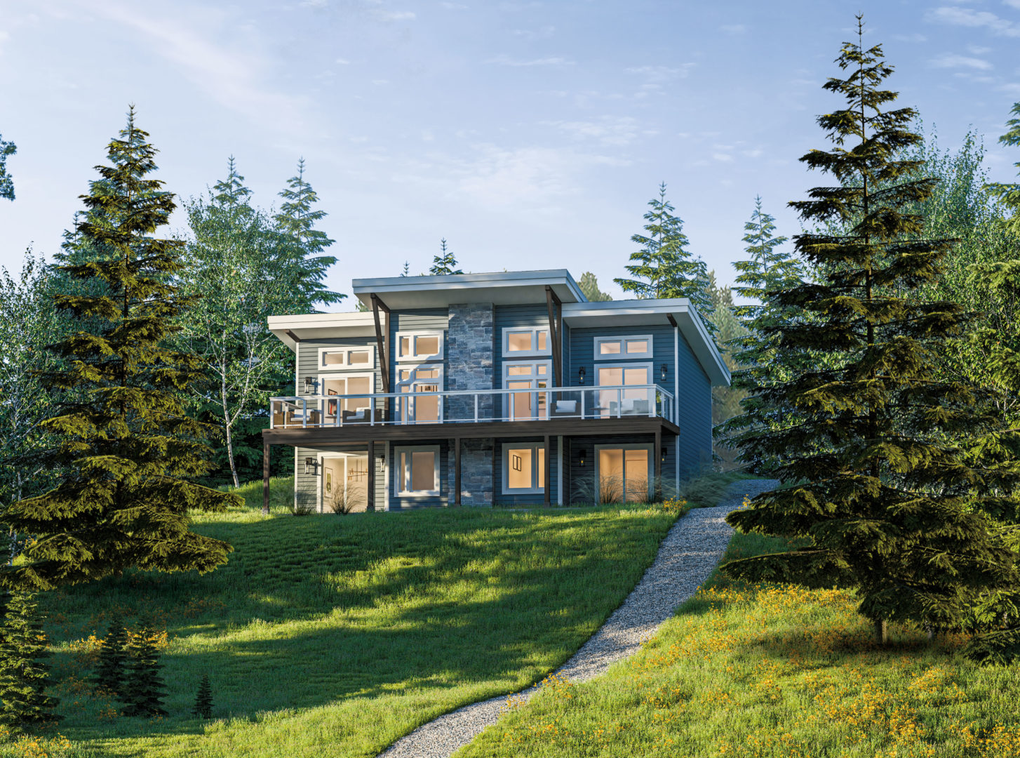 A large cottage with many windows, sitting at the top of a grassy hill surrounded by trees.