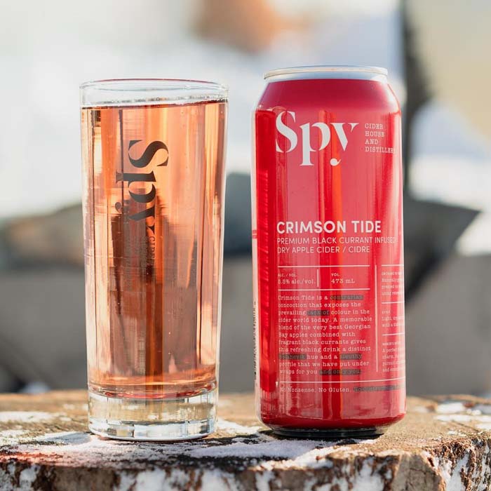 Spy Distillery Crimson Tide Cider on a tree stump